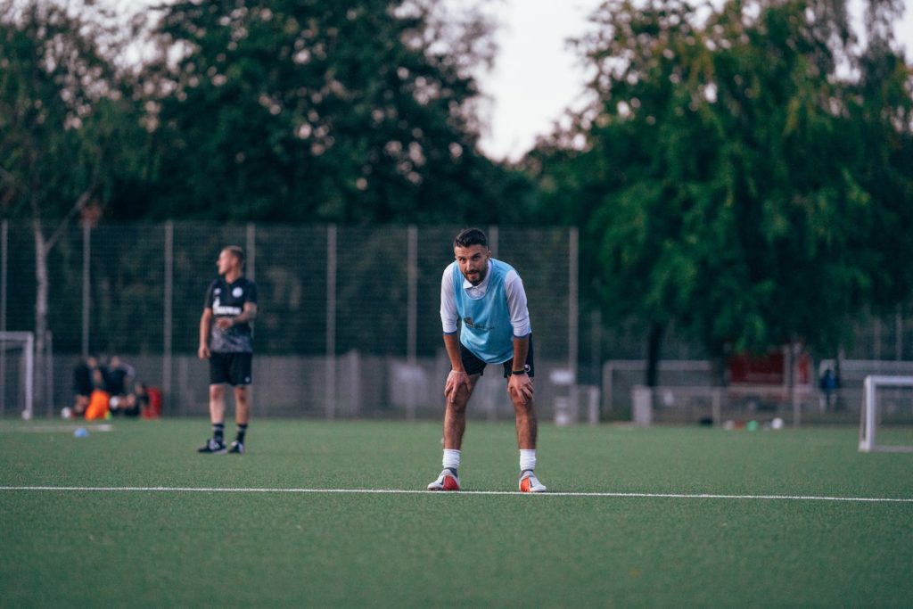 Football player standing in field during training