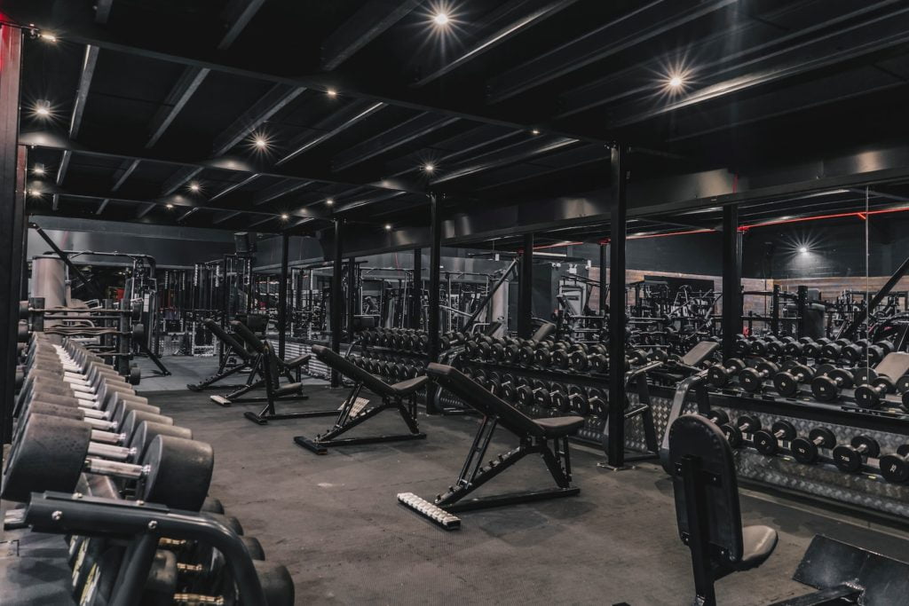 a gym filled with lots of machines and weights
